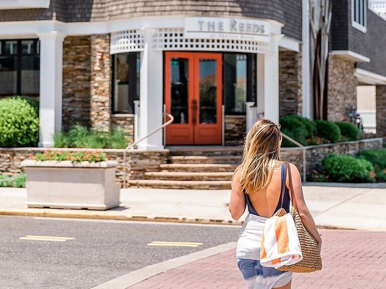 Woman walking in front of The Reeds at Shelter Haven in New Jersey