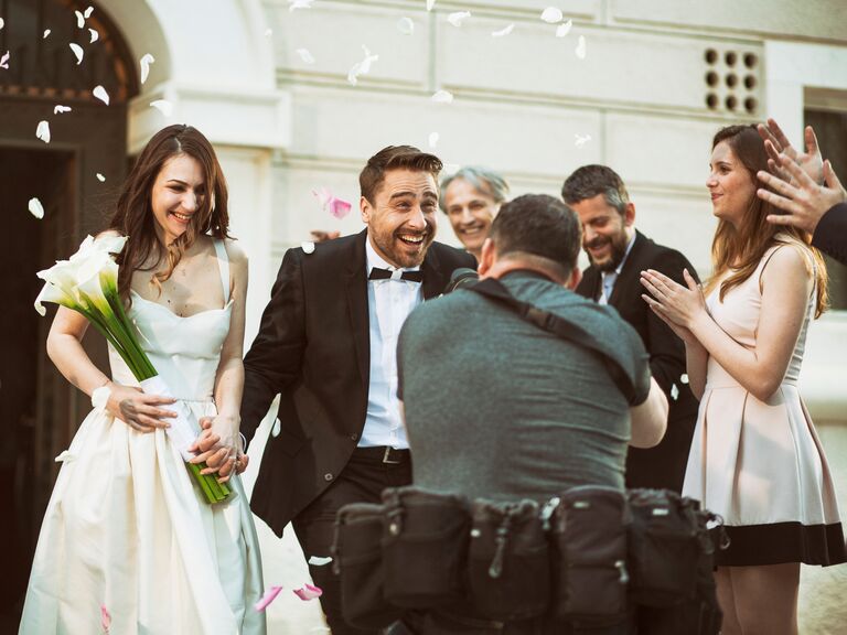 Photographer taking picture of newlywed couple
