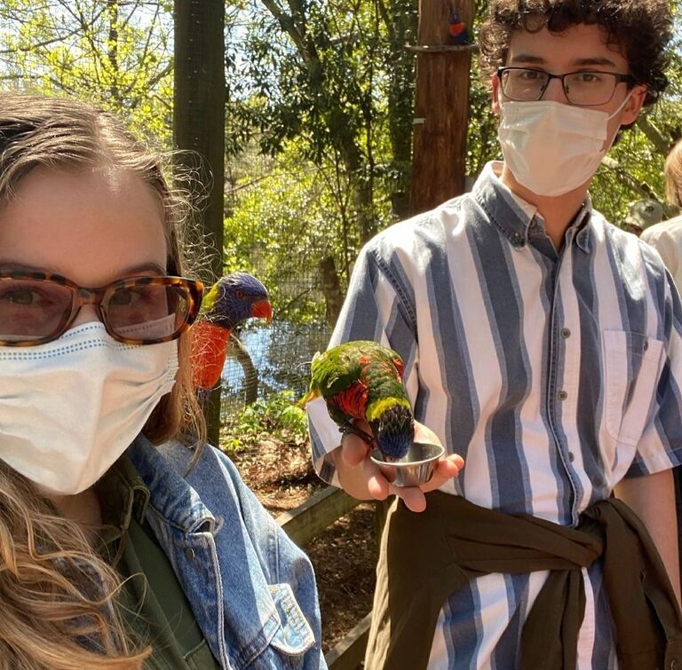 The happy couple meets some colorful birds at the Birmingham Zoo. 