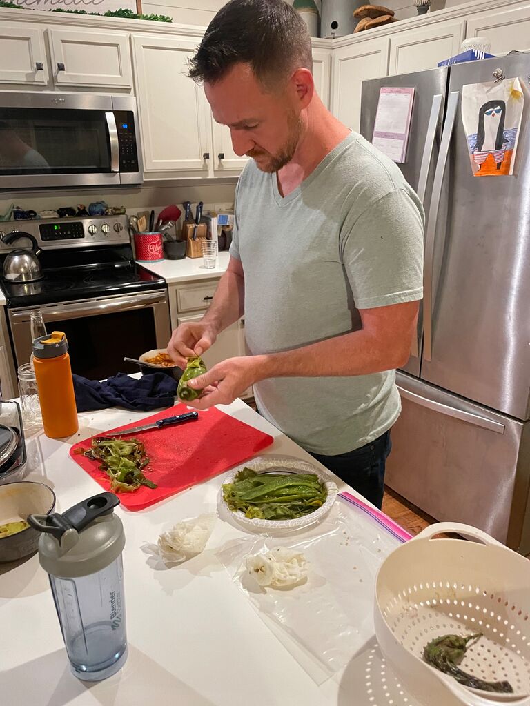Converting Tom into a New Mexican with green chile peeling lessons!
