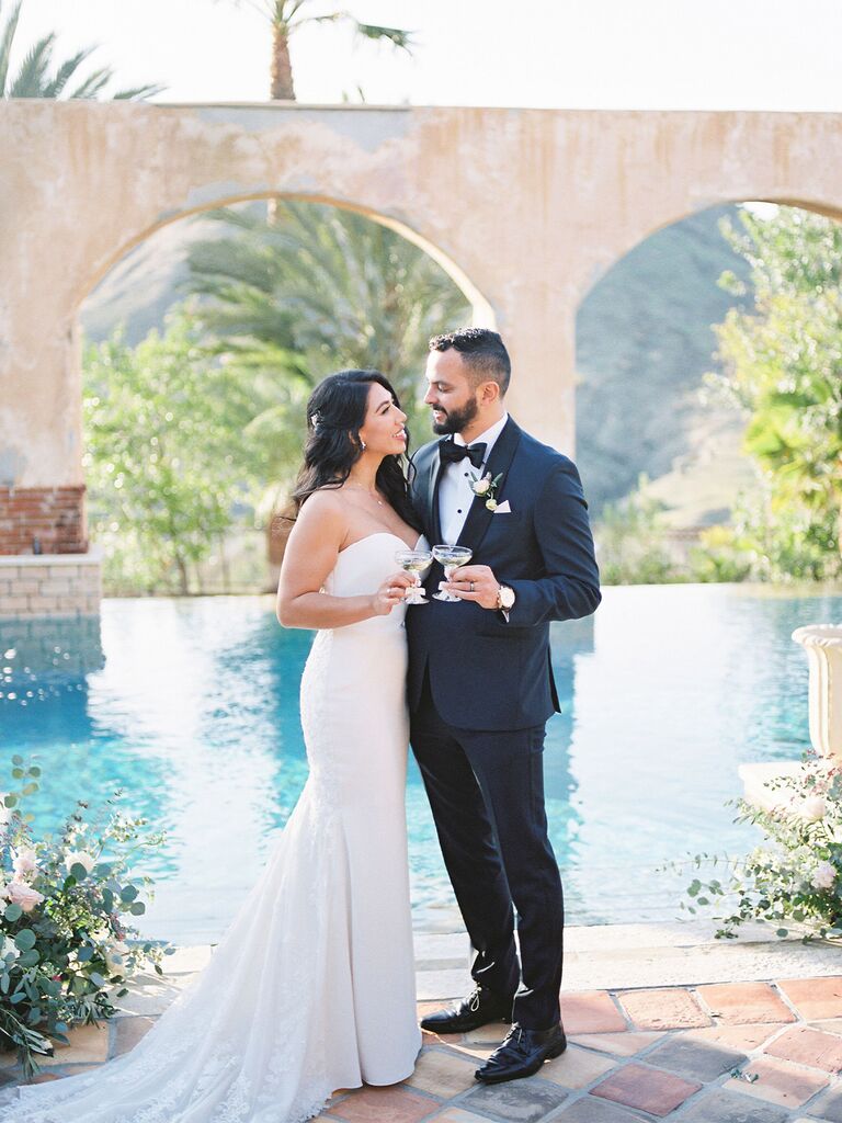 Couple by the pool at their wedding venue