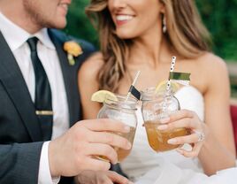 Bride and groom with signature cocktails