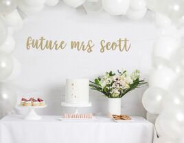 Bridal shower banner that says "Future Mrs. Scott" in glittery gold letters