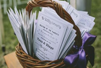 Wedding ceremony programs in a basket