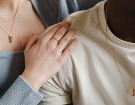 Couple wearing matching necklaces