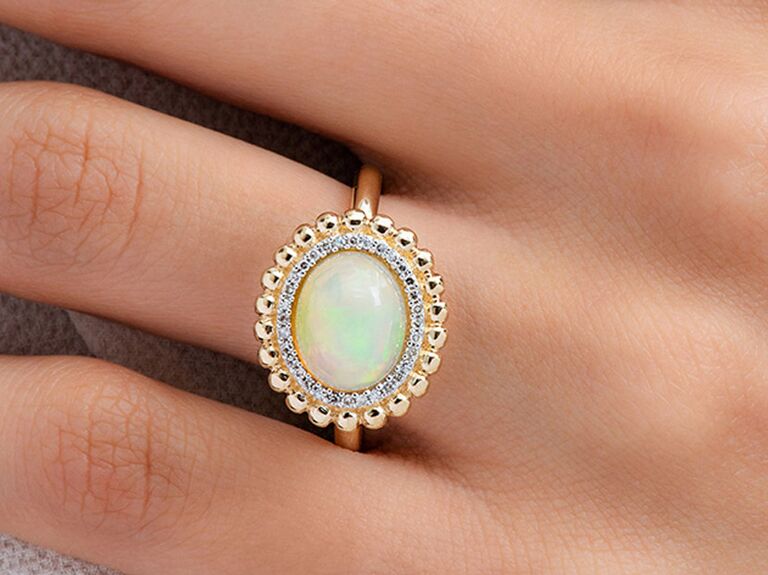 Opal engagement ring with gold beaded halo