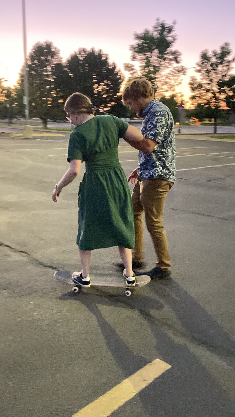 Jalen keeping Abbi from killing herself on a skateboard.