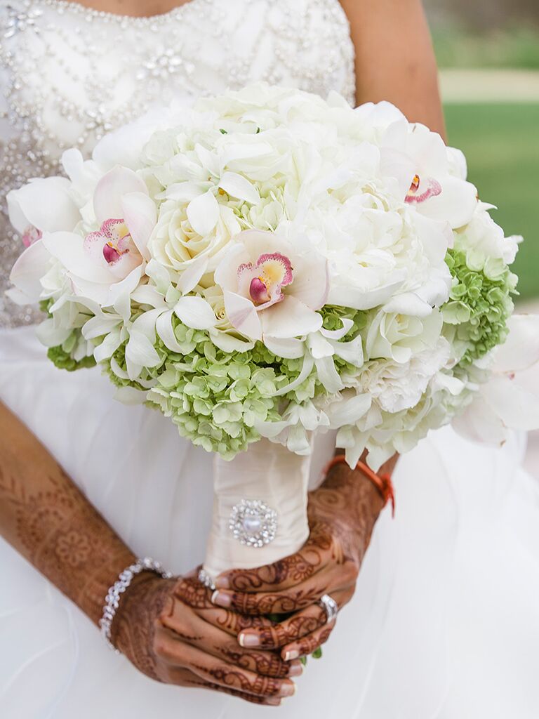White bridal bouquet with hydrangeas, orchids and a blingy brooch accent