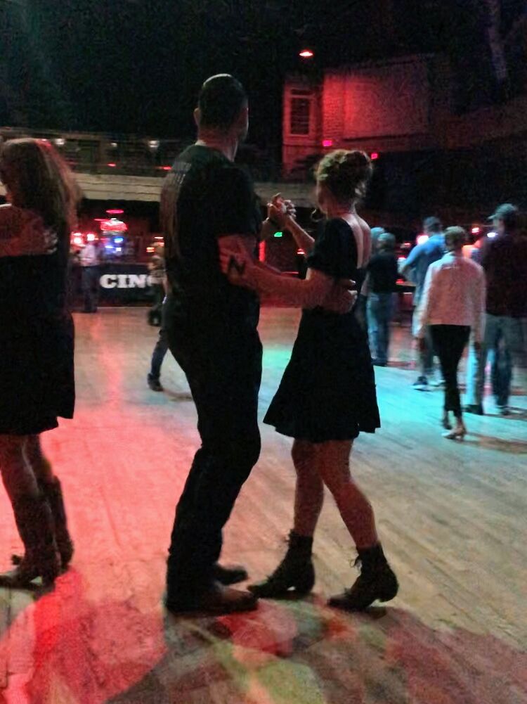 EJ has a terrible day at work and needs a distraction. He decides to test his previously injured leg at a beginner's country dance lesson.
Minavet realizes she hasn't been out of the house in a couple months and her time in Texas is almost up. She decides to take a country dance lesson.
EJ sees a beautiful girl walk into the dancehall and wonders who she is. Minavet inadvertently chooses the spot accross from EJ and they are matched up. Minavet soon discovers that EJ already knows how to dance and EJ gets her number.