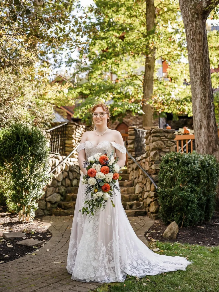 A bride walks down the aisle outdoors at Landoll's Mohican Castle