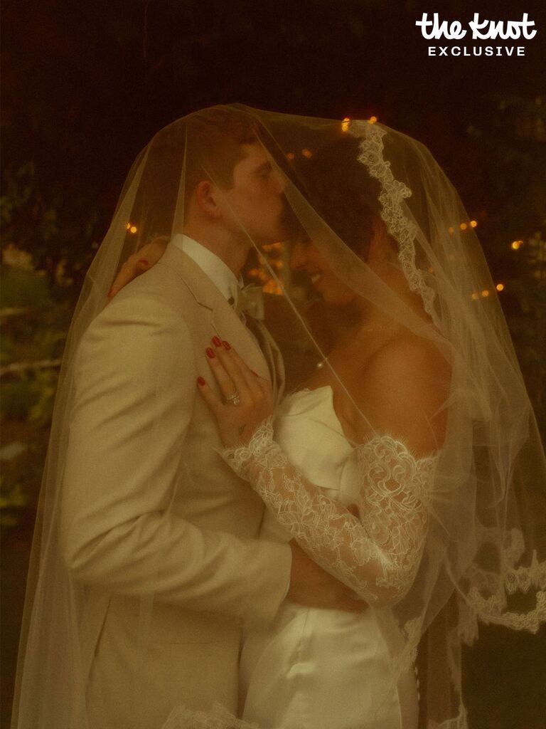 Tommy Winkler kissing wife Jess Pappas on their wedding day