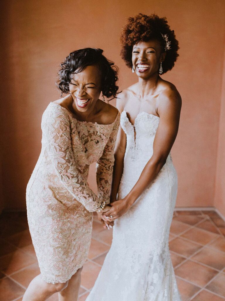 bride laughing with mother of the bride