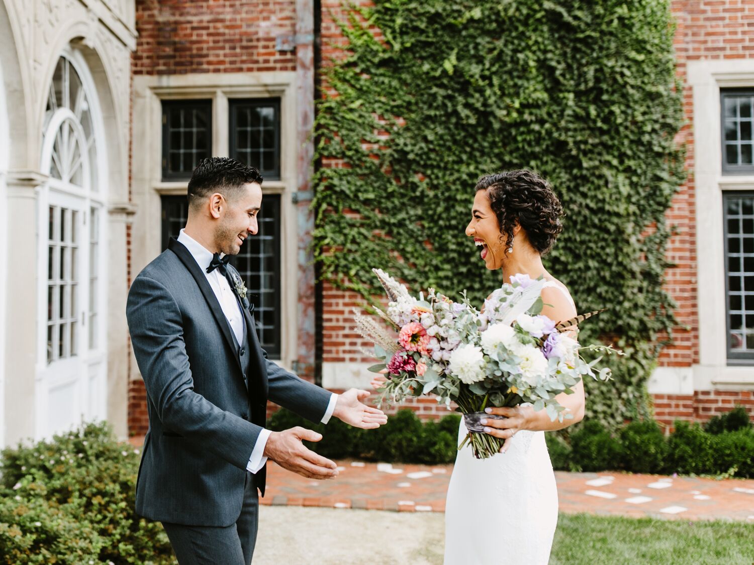 bride and groom smile during wedding first look