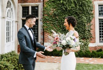 bride and groom smile during wedding first look