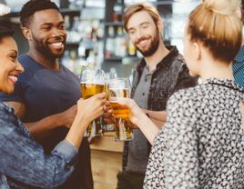 group of people toasting with beer