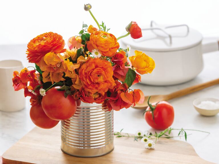 Orange ranunculus arrangement with ripe tomatoes reprinted from The Flower Chef by Carly Cylinder