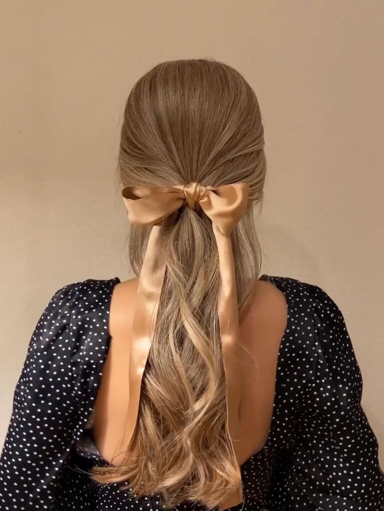 Wedding guest hairstyle with bow clip for long hair