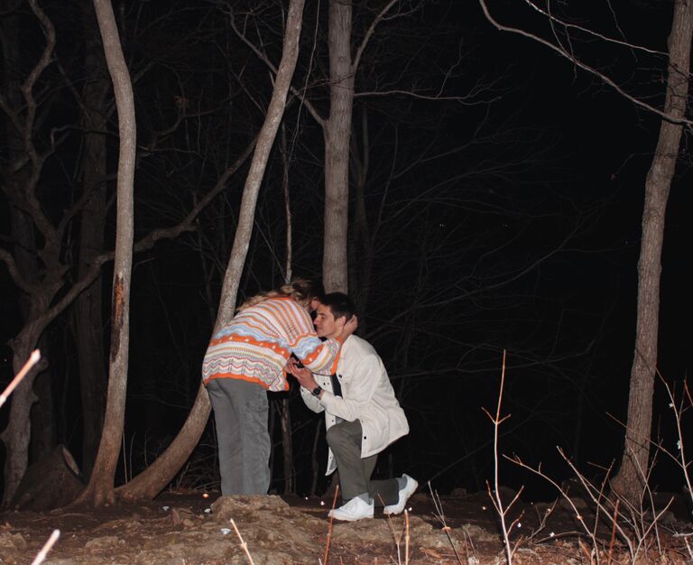 Zach proposes<3

We made plans with our good friend Owen to get wings at Time Out Tavern in La Crescent. Owen was talking about how he has to pick up a kitten litter box afterwards that someone sold to him from Facebook marketplace. We were at dinner and Zach got a call that he missed a “meeting” for track. He left and said Owen can give Enya a ride home. Owen said that’s fine if she is okay with picking up the litter box with him after. We were eating wings and so naturally Enya got sauce ALL OVER and was dressed like a slob. When Enya went to go wash her hands and face in the restaurant bathroom, it came to her that this might be happening. Enya ran out the bathroom, Owen couldn’t keep a straight face when she asked him, and she told him to “take me home so I can change and wash my face!” After quickly going home to clean up, Owen drove Enya to the proposal site. When Owen and Enya arrived at the La Crescent Apple orchard look out, there was a trail of 100 candles leading down to another smaller outlook where there were more candles on the edge. Zach proposed. 
