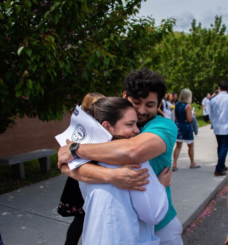 Hannah gets her white coat at the completion of her second year of medical school, with Jonathan's full support! 