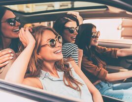 Girls wearing sunglasses and driving