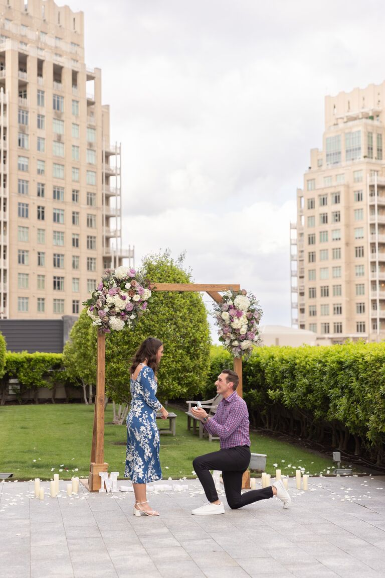 Jake proposed to Lydia at the Rockefeller Rooftop garden in the Harwood District of Dallas. For context, this garden/rooftop site is located in the middle of the city, and on the 12th floor of a retail/office building, above a restaurant. In the weeks leading up to the proposal, Jake had been plotting the Date Night with a  "distraction" plan to keep the proposal a surprise and come up with a reason for why we would be going to this rooftop location. He told Lydia that Mercat Bistro (the restaurant below) recently opened a new rooftop bar and that we should grab drinks there before eventually going to dinner at that restaurant. Lydia, being the planner she is, decided to search for this so-called rooftop bar's menu the day-of to plan out her drink order. To her surprise, Google was not aware this bar existed. Jake had to quickly pivot to make an excuse that it was SO new that they were lacking on social media presence and that we should check it out anyway. We made our way up to the 12th floor of the space and approached a private, decorated floral garden with candles and "Marry Me" signage waiting in the middle of the patio. This was a special moment we got to share together just the two of us (and a photographer). After the proposal, Jake had one more surprise for Lydia waiting at our favorite restaurant, Monarch, in Dallas. Awaiting us at the lobby were both of our families and champagne, ready to celebrate. We spent the rest of the weekend celebrating with family and friends in what made for an unforgettable engagement.