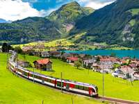 Electric red tourist train in swiss village Lungern, Switzerland