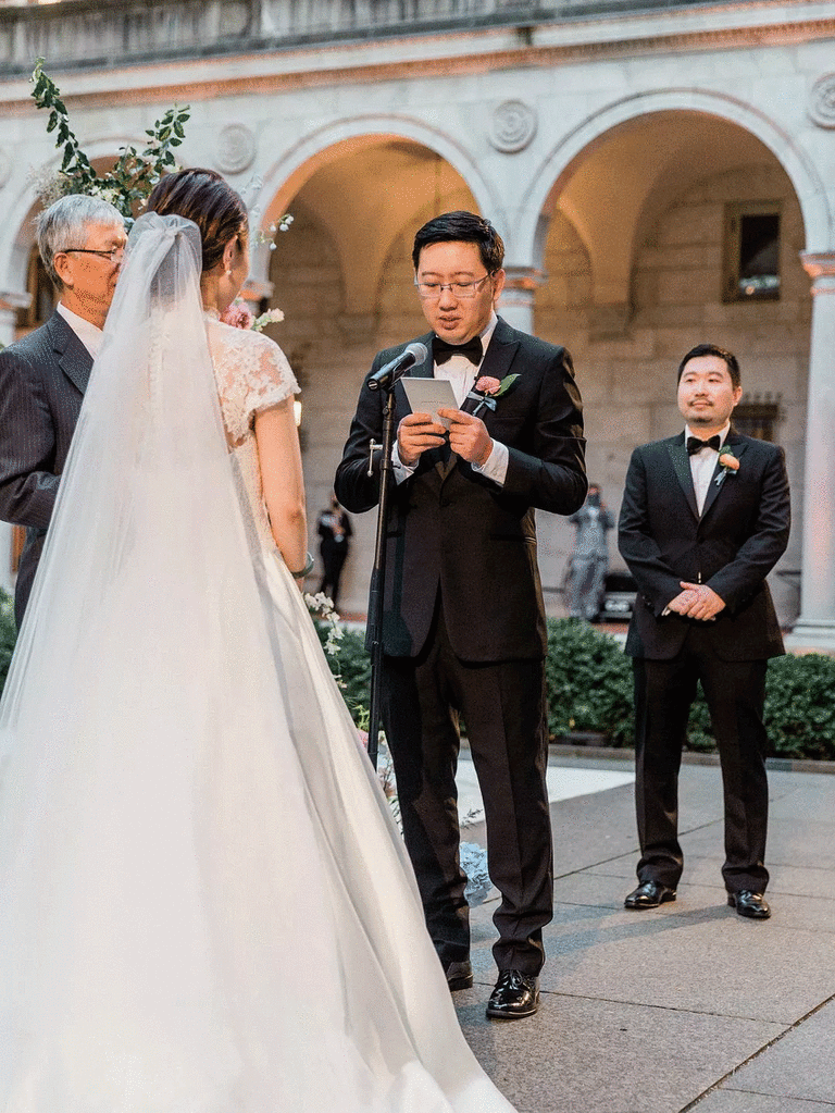 Groom reading his unique wedding vows to the bride. 