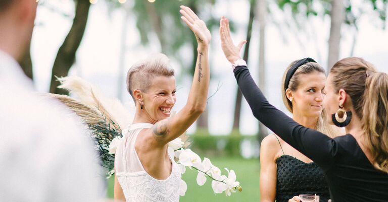 bride celebrating with friend after planning her own wedding