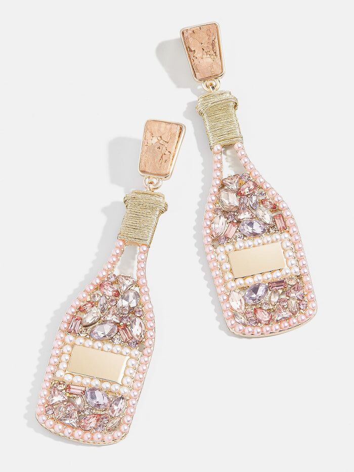 A pair of champagne bottle statement earrings in rose gold from BaubleBar