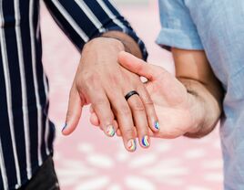 Lgbtq engagement rings on hands