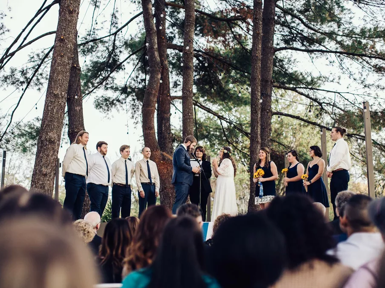 A couple tie the knot in a natural outdoor wedding ceremony space at Studio 615
