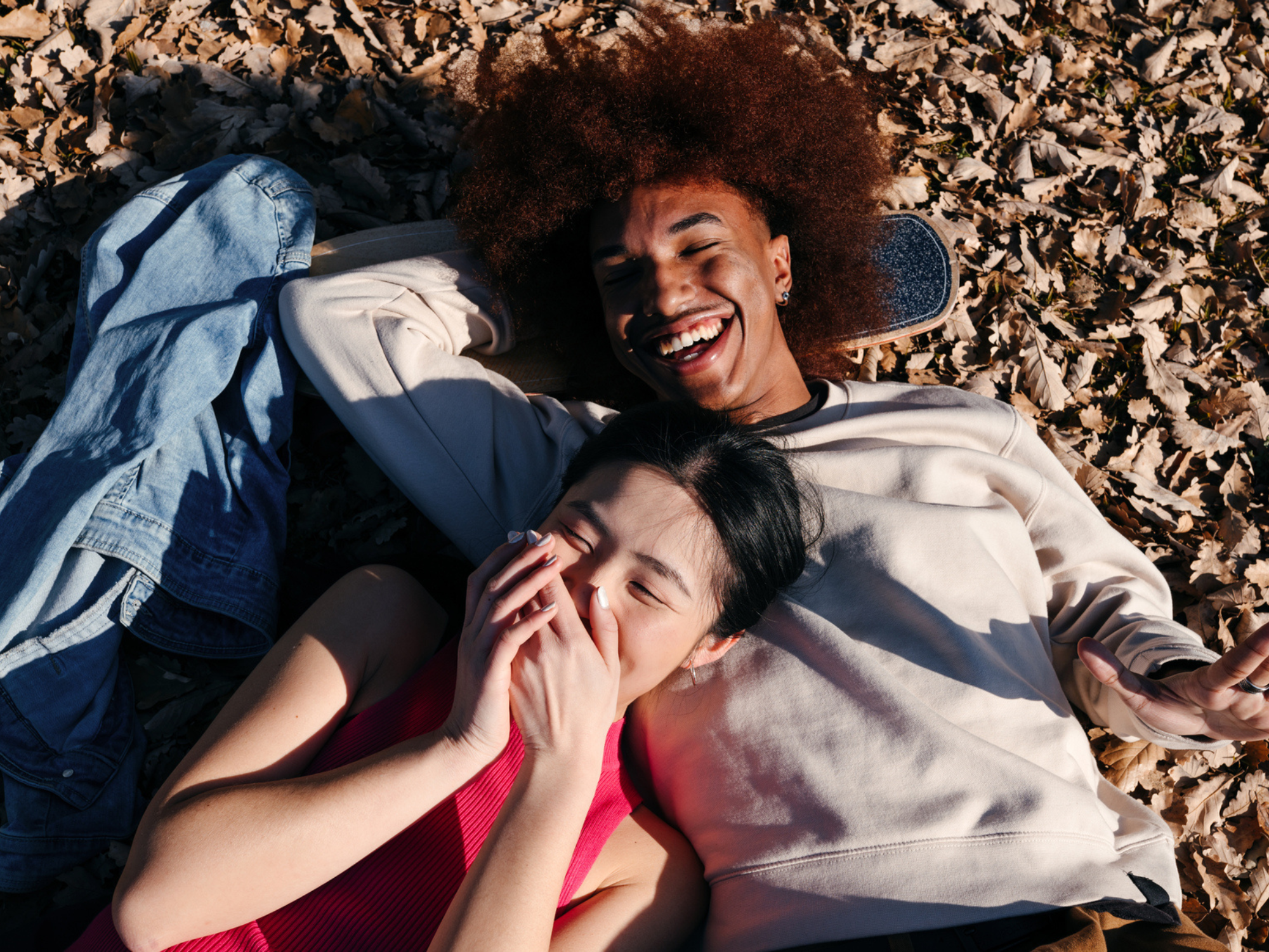 Couple laying on leaves in fall, best fall captions