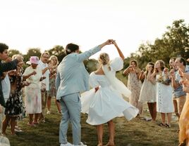 Bride and groom dancing down the aisle on wedding day