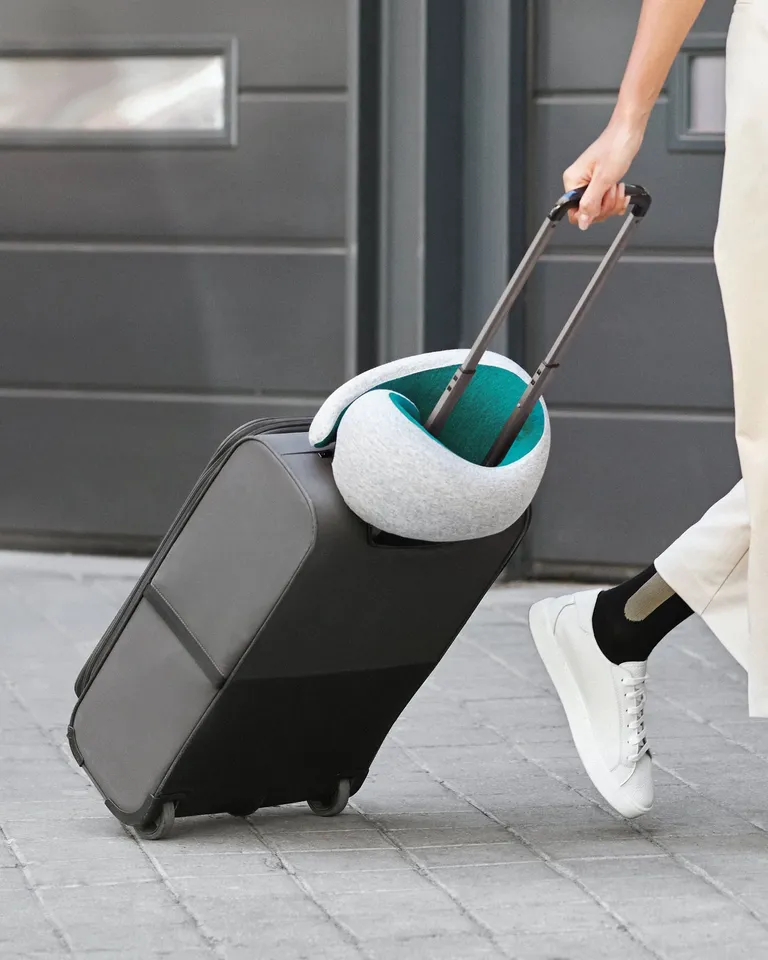 ostrichpillow wrapped around a suitcase handle 