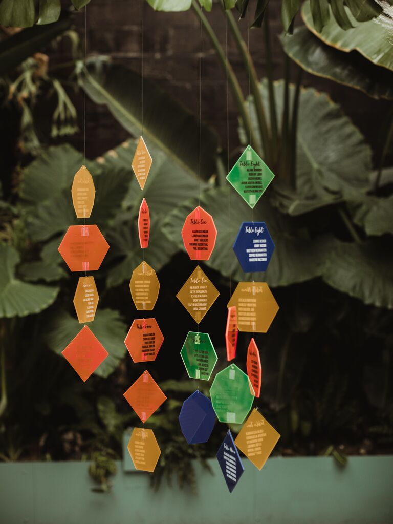 Colorful acrylic shapes hanging as part of a seating chart