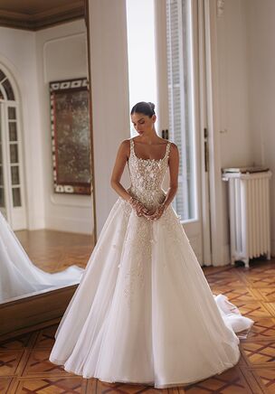 November — round neck sleeveless corset-based dress with meticulous embroideries on the top and descending to the skirt and vanishing towards the bottom of voluminous tulle skirt. Complemented by transparent gloves embroidered in the same style and a detachable embroidered veil.