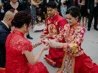 Couple serving tea to parents during Chinese wedding tea ceremony