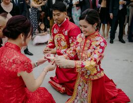 Couple serving tea to parents during Chinese wedding tea ceremony