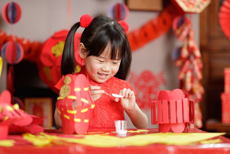 Young girl making lanterns for Chinese New Year