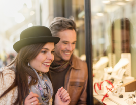 Couple smiling while engagement ring shopping