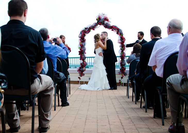 Ceremony With Red Black And White Wedding Arch