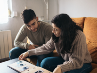 Couple putting together wedding scrapbook