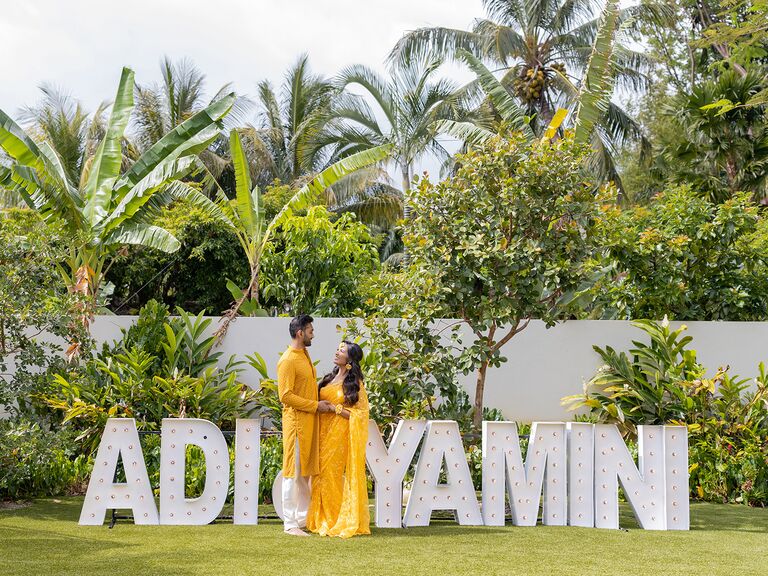 couple beside marquee letters 