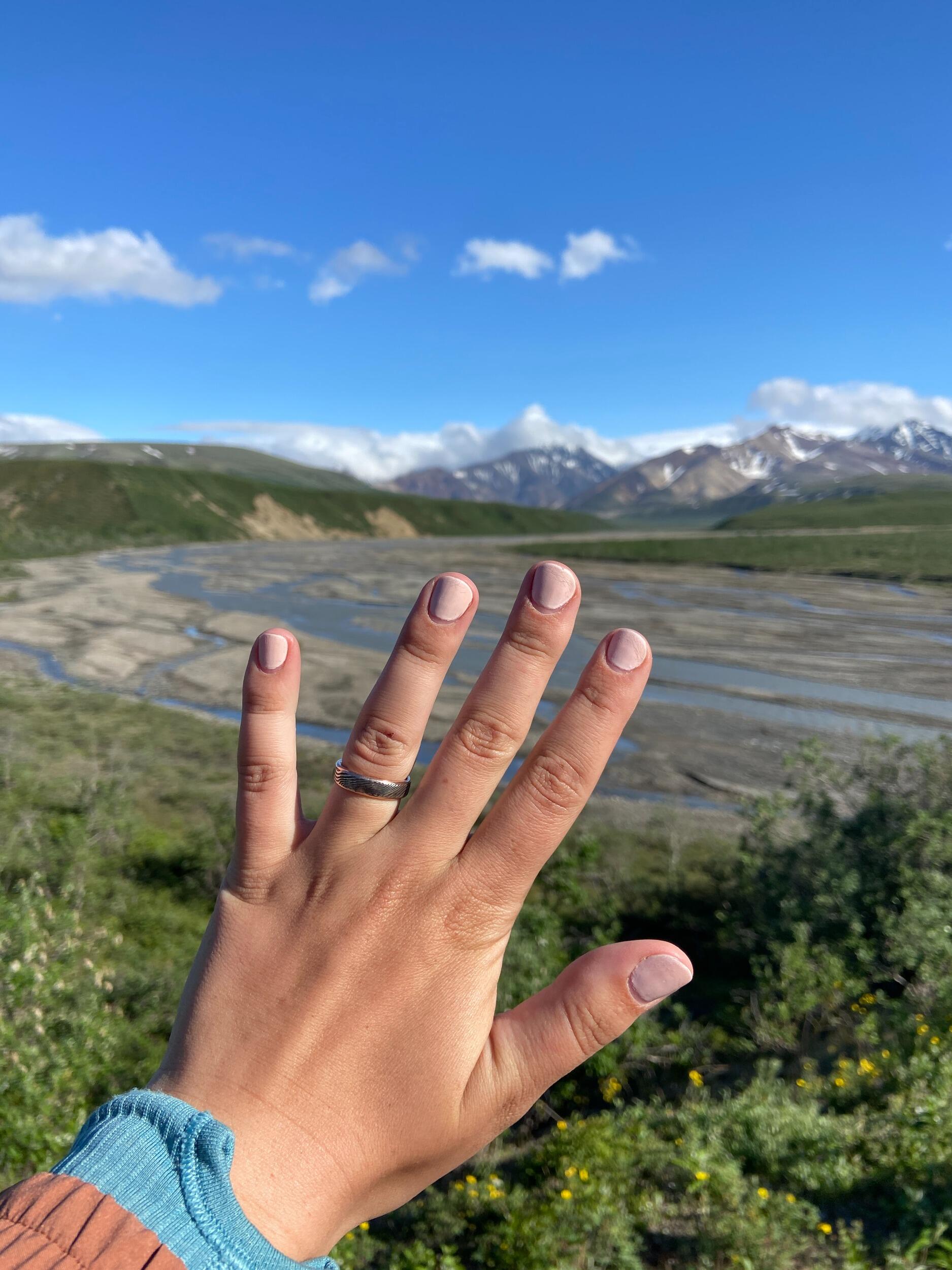 The ring Kyle made for Kiana made it all the way from the forgery in Pittsburgh, Pennsylvania to Denali National Park. It's handmade by Kyle out of rose gold and Damascus steel.