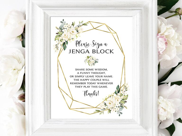 'Please sign in' in black script in gold geometric border with white flowers in white frame