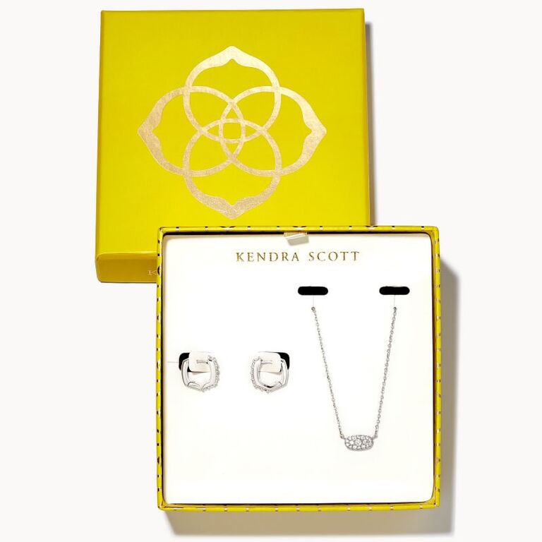 A white crystal necklace with matching huggie earrings from Kendra Scott