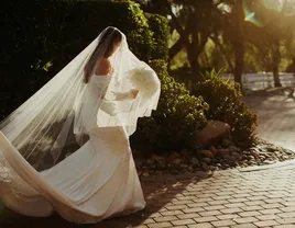 Bride walking with long veil and dress train