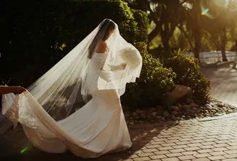 Bride walking with long veil and dress train
