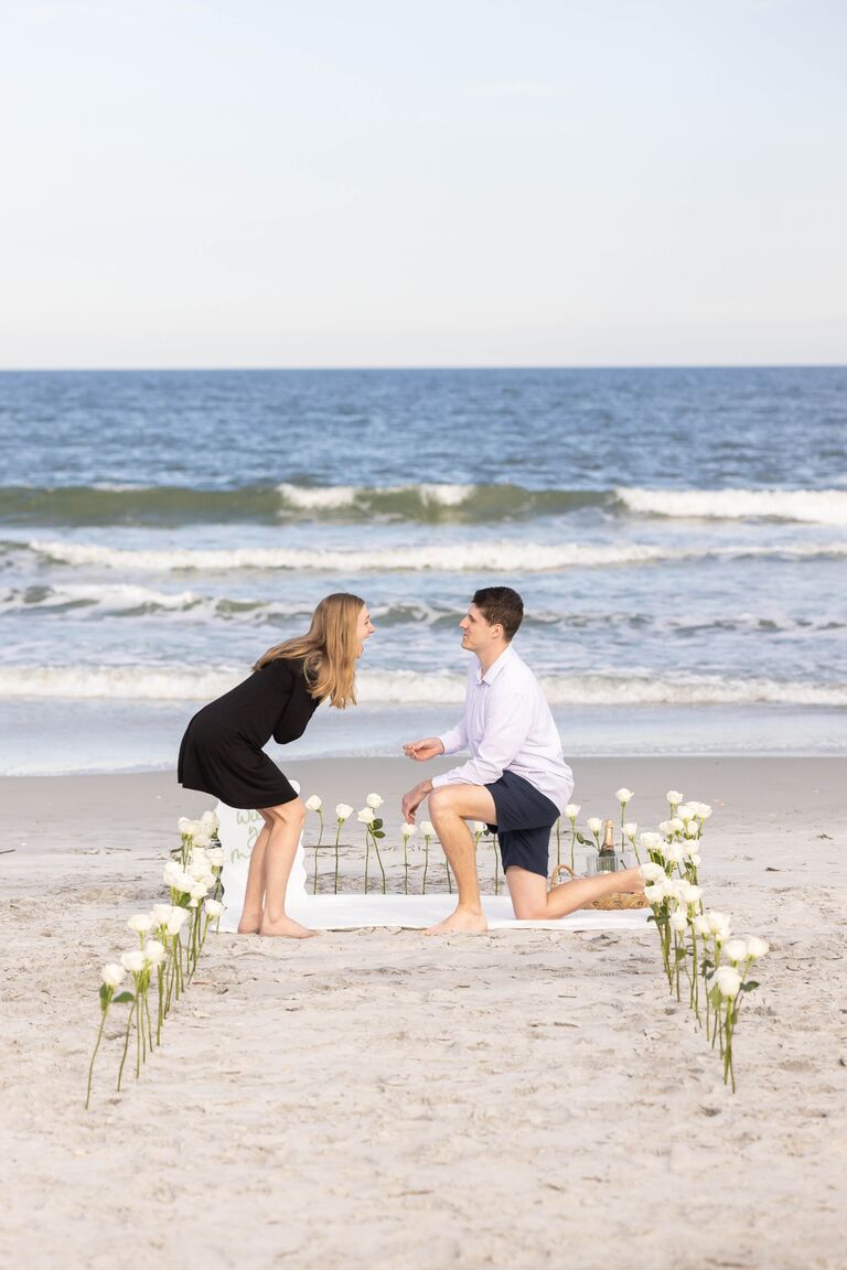 I was fully convinced I would know everything going on the day Jack proposed. Boy was I wrong! On Sunday, Jack took me to Anastasia State Park and surprised me with a hundred white roses lining the romantic setup he envisioned. There was champagne, custom glasses, and a beautiful sign saying "Will you marry me?". Jack had my best friend (& incredibly talented photographer) fly in from Texas to capture the entire thing somehow without me knowing! Then, he got down on one knee and asked me to be his wife... surprise, I said yes!