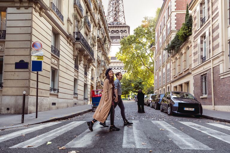 A couple strolling down a street in Paris, France